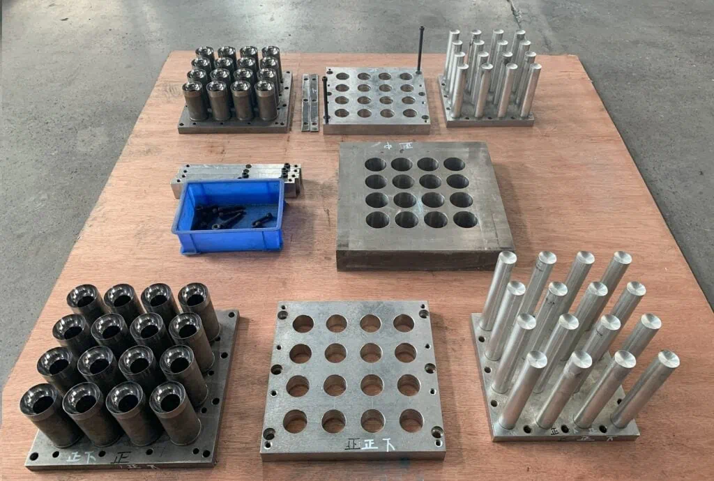 Knolling arrangement of a complete mold set, including upper, middle, and lower molds, demonstrating the complexity of the mold components.