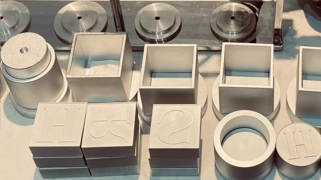 Molds for the pneumatic bath bomb press, featuring various shapes including square and round designs, design for easy replacement